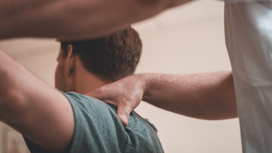 Fysioterapeut undersöker en patients arm